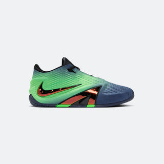 A Nike indoor soccer shoe featuring a green-to-blue gradient upper, a metallic orange-red Swoosh, and a dark blue textured toe cap, shown against a light gray background.